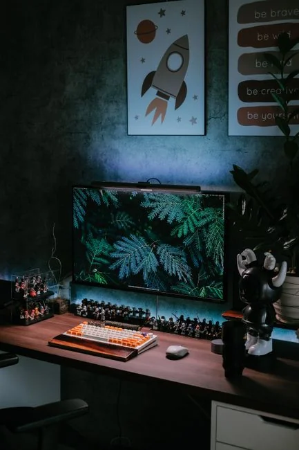 A bright modern office setup with computers and a mug on a desk.
